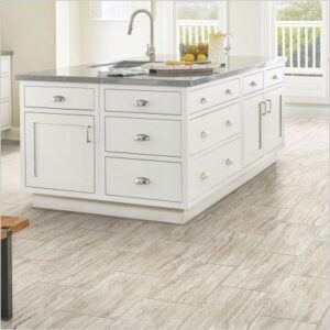 Large white kitchen island with neutral tile floor